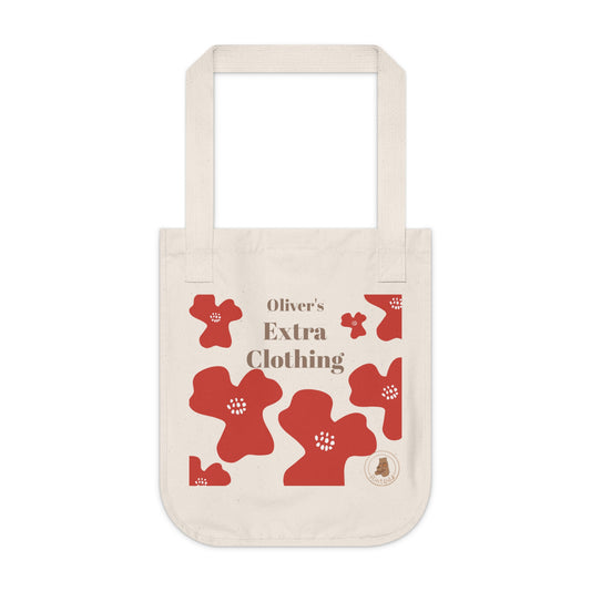Beige tote bag with red floral patterns and 'Oliver's Extra Clothing' text on a white background