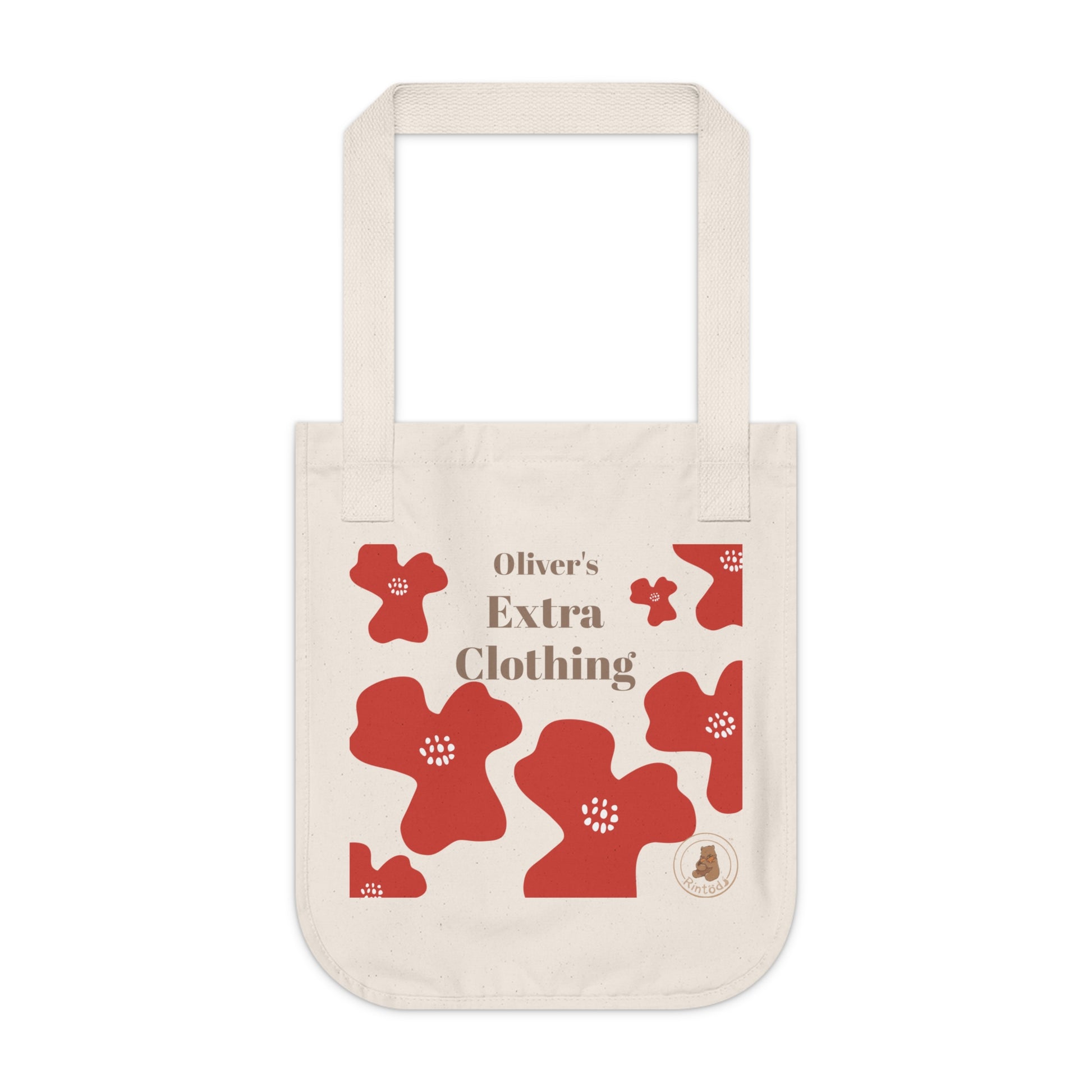 Beige tote bag with red floral patterns and 'Oliver's Extra Clothing' text on a white background