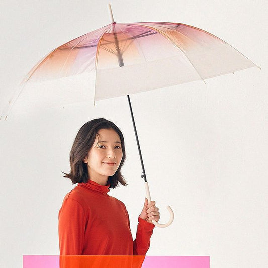 Woman holding a transparent umbrella with a pink and orange gradient on a white background