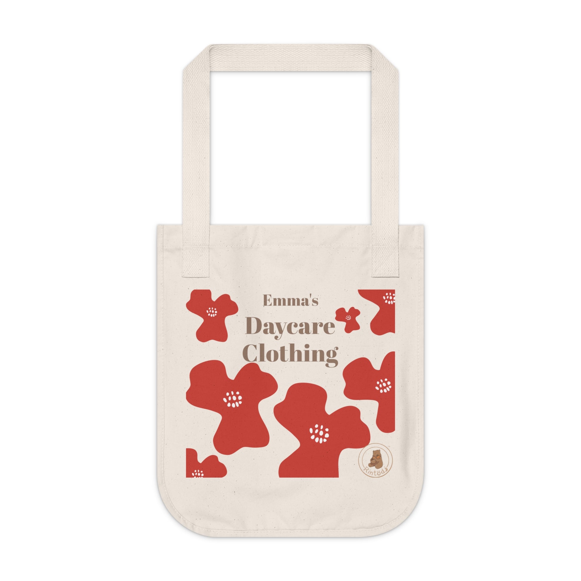 Beige tote bag with red floral designs and customisable text on a white background