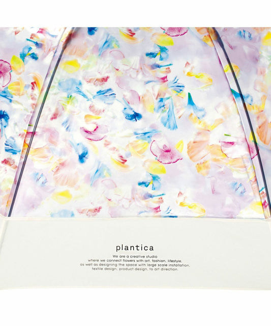 Close-up of the limited edition Wpc x Plantica Joyful Floral umbrella in the Multi-color sweet pea and ranunculus pattern, featuring the plantica logo.